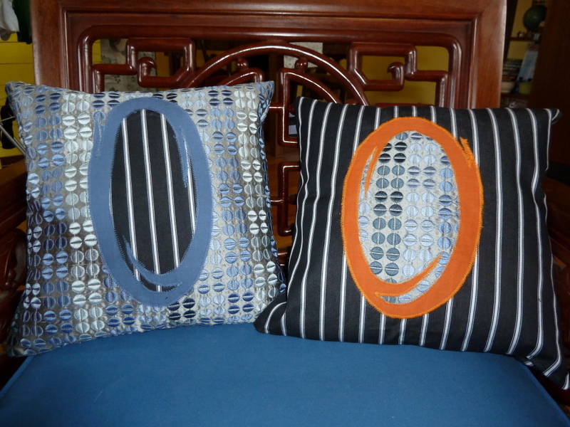 Two cushions with portals from the game Portal